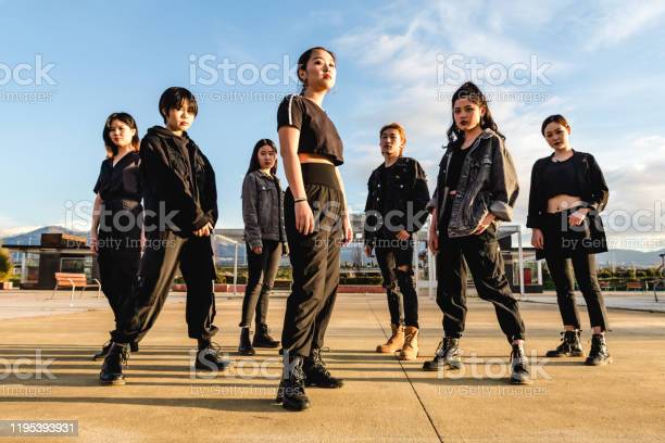 Young Asian team posing looking at camera. Chinese teenage friends
